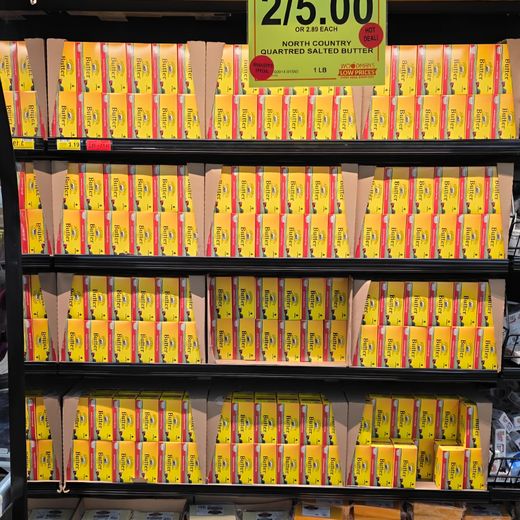 North Country butter merchandised on a grocery store shelf with sale pricing